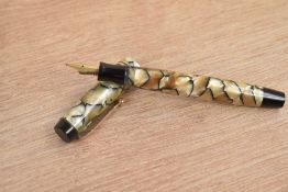 A Parker Duofold Special button fill fountain pen in black and pearl with two gold bands to the