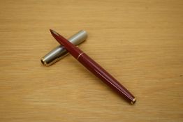 A Parker 61 capillary fill fountain pen in rage red with lustraloy cap with gold trim