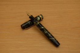 A Parker Duofold Standard button fill fountain pen in green and black marble with broad gold cap
