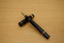 A Parker Duofold Centennial converter fill fountain pen in black with gold trim and one broad one