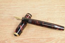 A Parker Vacumatic Junior button fill fountain pen in burgundy and black marble with two gold band