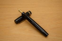 A Parker Duofold Senior button fill fountain pen in black with two gold bands to the cap having
