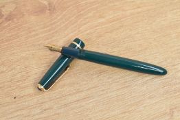 A Parker Slimfold aerometric fill fountain pen in green with single gold chevron cap band having