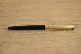 A Parker 61 ballpoint pen in black with rolled gold cap