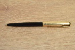 A Parker 61 ballpoint pen in black with a rolled gold cap