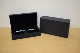 A boxed Parker Duofold ballpoint pen in check marine with chrome trim.