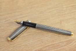 A Parker 75 Cicele converter fill fountain pen in sterling silver with gold trim having a Parker 14k
