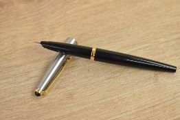 A Parker 45 converter fill fountain pen in black with lustraloy cap with gold trim.