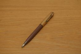A Parker 51 propelling pencil in cocoa with rolled gold cap.