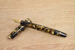 A Parker Duofold button fill fountain pen in light and dark brown pearl with single gold band to the