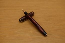 A Parker Royal Challenger Standard button fill fountain pen in red and black striated marble with
