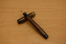 A Parker Duofold Junior button fill fountain pen in brown and black herringbone pattern with two
