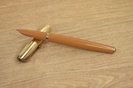 A Parker 51 vacumatic fill fountain pen in mustard with a rolled gold cap with blue diamond clip.