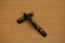 A Parker Duofold Junior Streamlined button fill fountain pen in green and black marble with two
