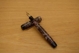A Parker Duofold button fill fountain pen in what may have been rose marble but faded with two