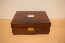 A fitted Rosewood lapdesk with leather skivver and fitted inkwell having brass fittings