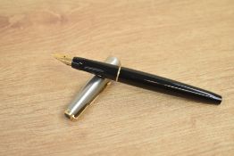A Parker VP converter fill fountain pen in black with a flighter cap with gold trim having a