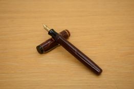 A Parker Premiere button fill fountain pen in mahogany with single gold cap band having Parker