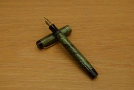 A Parker Duofold Junior button fill fountain pen in green and black herringbone pattern with two