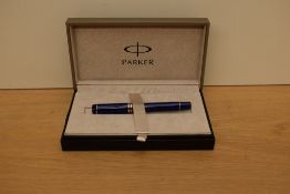 A boxed Parker Duofold International converter fill fountain pen in Lapis lazulii with gold trim