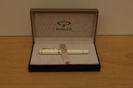 A boxed Parker Duofold Centennial converter fill fountain pen in Ivorine white with gold trim having