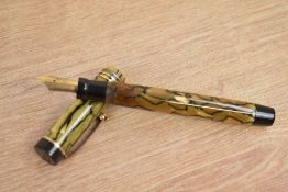 A Parker Duofold Special Lucky Curve button fill fountain pen in black and pearl with three gold