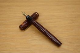 A Parker Premiere button fill fountain pen in mahogany with single gold cap band having Parker