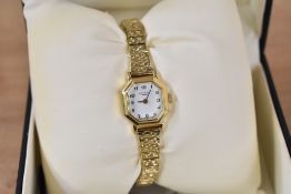 A small gold tone Rotary wristwatch, the octagonal white dial having Arabic numerals, in Rotary box