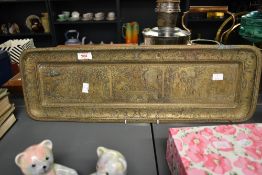 An early 20th century oblong brass tray highly, intricately decorated with Chinese male and female