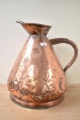 A large 19th century copper 4 gallon measuring jug, impressed mark '36' to rim, h41cm.