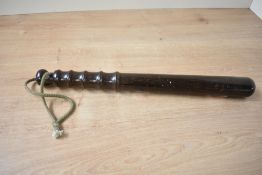 An early 20th century solid turned mahogany police officers truncheon with ribbed grip, L38cm.