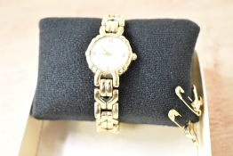 A Raymond Weil wristwatch, the circular white dial having four Roman numerals, on a gold tone