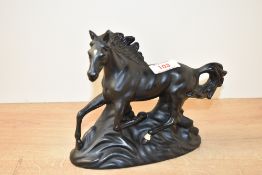 A vintage porcelain study of a black stallion running, h16cm.
