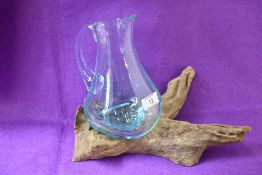 A contemporary Indonesian planter, hand crafted from root wood with one moulded transparent glass