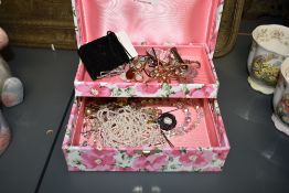 A floral motif two-tier jewellery box, containing a small assortment of costume jewellery