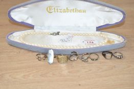 A string of cultured pearls of even form with a silver fish hook clasp, approx 16'