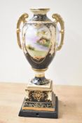 A late 19th Vienna porcelain style urn vase, mounted on a wooden block and decorated with