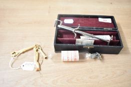 A vintage ear piercing kit, sold together with a pair of 9ct gold stud earrings weighing approx. 0.