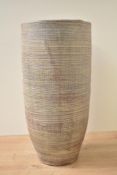 A contemporary terracotta cylinderical vase, sticker to base 'Made in Thailand' h39cm.