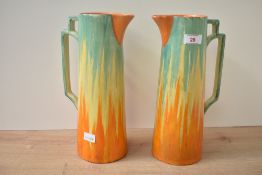 A pair of vintage Wadeheath pottery jugs in the Art deco style, decorated with orange, yellow and