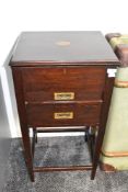 An Edwardian mahogany sewing stand, having two drawers fitted with brass campaign style handles,