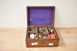 A wooden jewellery box, containing an assortment of costume jewellery including cufflinks, brooches,