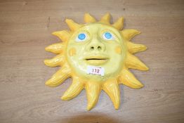 A mid 20th century hand made ceramic sun plaque, signed 'Rodney Y.C', w30cm.