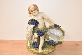 A Capodimonte style figure depicting a young boy with basket having blue berry decoration,