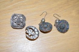 A small selection of white metal jewellery, comprising a paste set crescent and star brooch, a