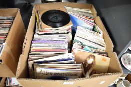 A large box of 7' mixed genres singles, to include The Beatles Twist and Shout, The Clash