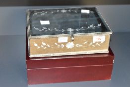 A mirrored jewellery box having floral decoration, containing a small assortment of costume