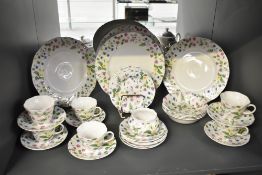A Queens fine bone China Country Meadow pattern dinner service, hand coloured in pink, purple,