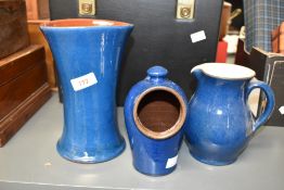 Three Wetheriggs of Penrith pottery, decorated in blue glaze, to include a water jug, 14cm, a