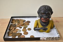 An early 20th century cast iron Dinah money bank in polychrome paint, including a mixture of